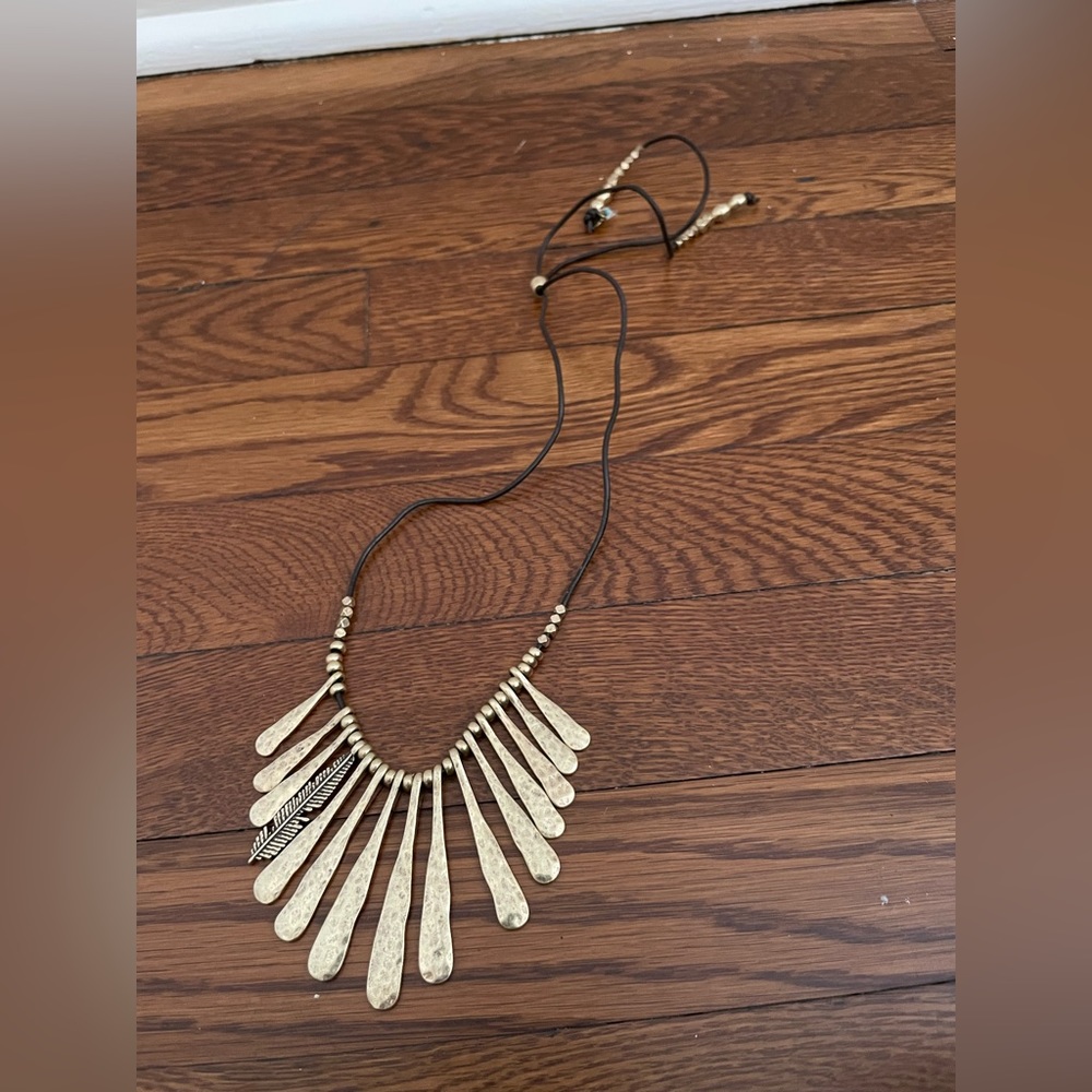 Golden collar necklace with black string